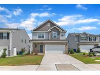 Charming two-story home featuring a two-car garage and manicured front lawn at 3505 Triad Ct, Raleigh, NC 27604