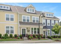 Charming townhouse featuring colorful exteriors, well-manicured landscaping, and inviting front entrances at 513 Brooks St, Wake Forest, NC 27587