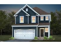Two story home featuring board and batten siding, a two car garage, and a covered entry at 529 Prestonfield Way, Raleigh, NC 27603