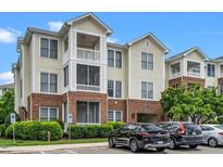 Attractive condo building featuring a blend of brick and siding, multiple balconies, and convenient parking at 734 Portstewart Dr, Cary, NC 27519