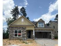Charming, single-story home boasts stone accents, an inviting entrance, and a spacious two-car garage at 75 Slippery Elm Rd, Youngsville, NC 27596