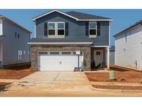 Two-story home features blue siding, a gray brick garage, black shutters, and a concrete driveway at 808 Ottawa Dr, Garner, NC 27529