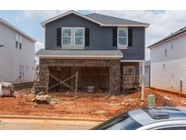 Two-story home featuring brick accents, a two-car garage, and gray siding at 808 Ottawa Dr, Garner, NC 27529