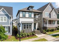 Charming two-story home with a covered porch and balcony, set in a well-maintained neighborhood at 1008 Whistler St, Durham, NC 27713