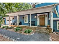 Charming brick home featuring a welcoming front porch with beautiful landscaping at 1426 Kildaire Farm Rd, Cary, NC 27511