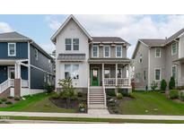 Charming two-story home with a landscaped front yard and inviting green-painted front door at 3310 Mission Olive Pl, New Hill, NC 27562