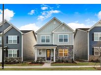 Charming two-story home with stone accents, inviting curb appeal, and a well-manicured lawn at 333 Natsam Woods Way, Wake Forest, NC 27587