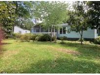 Charming single-story home with a well-maintained front yard and mature trees at 3555 Nc 98 Hwy, Youngsville, NC 27596