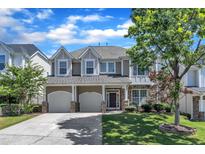 Charming two-story home featuring a two-car garage and manicured front lawn at 413 Westfalen Dr, Cary, NC 27519