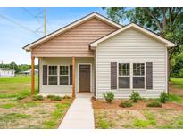 Charming home featuring a well-manicured lawn and inviting entrance at 414 S Center St, Princeton, NC 27569