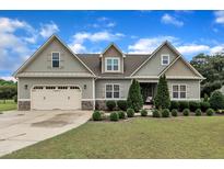 Charming craftsman home featuring a well-manicured lawn and an attached two-car garage at 71 Smithsanders Ct, Smithfield, NC 27577