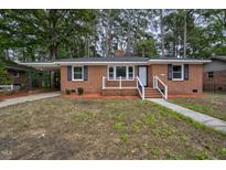 Charming brick ranch-style home featuring classic black shutters and a cozy front porch at 813 Burton St, Rocky Mount, NC 27803