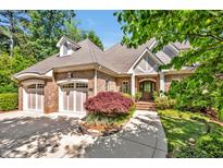 Charming brick home featuring a two-car garage, landscaped front yard, and inviting entrance at 84307 Winslow, Chapel Hill, NC 27517