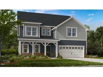 Charming two-story home with a covered porch, gray siding, and a two-car garage at 913 Delano Dr, Knightdale, NC 27545