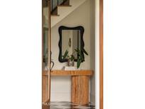 Charming entryway featuring a unique console table, decorative mirror, and stylish black and white tile flooring at 1113 Mordecai Dr, Raleigh, NC 27604