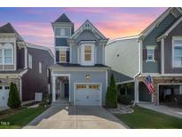 Attractive two-story home featuring an attached garage, turret, and well-maintained lawn at 1208 Brown Velvet Ln, Apex, NC 27523
