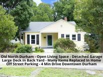 Charming yellow home with black shutters and well-maintained landscaping in a desirable Durham neighborhood at 1410 Shawnee St, Durham, NC 27701