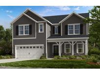 Two-story home featuring gray siding, a two-car garage, and well-maintained front lawn at 147 Rivulet Ct, Cary, NC 27519