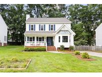 Charming two-story home with blue shutters, inviting front porch, manicured lawn, and mature trees at 16 Cedar Hill Dr, Durham, NC 27713