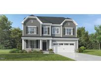 Two-story home featuring a gray exterior, well-manicured lawn, and a two-car garage at 1641 Goldfinch Perch Ln, Knightdale, NC 27545