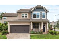 Charming two-story home with a well-manicured lawn and a two-car garage in a lovely neighborhood at 1924 Rustica Dr, Durham, NC 27713