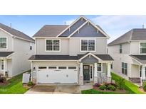 Charming two-story home with a two-car garage and lovely front porch with decorative wreath at 2177 Campbell, Burlington, NC 27215
