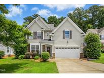 Charming two-story home featuring a well-maintained lawn, attached garage, and neutral siding for a welcoming curb appeal at 304 Forbes Rd, Wake Forest, NC 27587