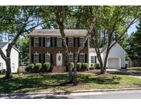 Charming brick two-story home with mature trees and well-manicured lawn at 3045 Creek Moss Ave, Wake Forest, NC 27587