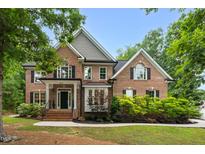 Charming brick home featuring meticulously maintained landscaping and architectural details at 3604 Thorndike Dr, Wake Forest, NC 27587