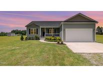 Charming single-Gathering home with attached garage and well-manicured lawn at 3724 Stevens Chapel Rd, Smithfield, NC 27577