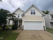 Charming two-story home with a two-car garage and well-maintained lawn at 3852 Cane Garden Dr, Raleigh, NC 27610