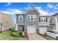 Charming two-story home with a one car garage, beautiful landscaping, and tasteful stone accents at 6549 Tremolo Trl, Raleigh, NC 27616