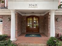 Brick building entrance with double doors, columns, and the building number at 10411 Rosegate Court # 6, Raleigh, NC 27617
