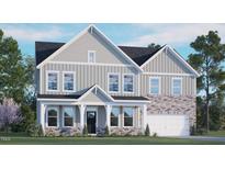 Two-story home with gray siding, stone accents, a covered porch, and a two-car garage at 1121 Dartford Green Pl, Wake Forest, NC 27587