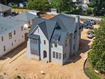 New construction home shows painted brick and black roof in a landscaped neighborhood at 1229 Dixie Trl, Raleigh, NC 27607
