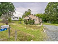 Charming home with a tidy front yard, inviting curb appeal, and mailbox at 1726 Morgantown Rd, Burlington, NC 27217