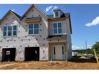 New construction home with covered entrance and multiple windows awaiting final construction touches at 173 Ripple Way # 204, Clayton, NC 27520