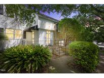 Charming two-story home with a stone facade, complemented by lush landscaping and a welcoming entrance at 1904 Smallwood Dr, Raleigh, NC 27605