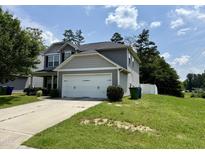 Two-story gray home with a two-car garage and a well-manicured lawn at 219 Trimble Dr, Elon, NC 27244