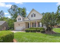 Charming two-story home with a well-manicured lawn, attached garage, and brick accents at 2333 Grey Gables Dr, Burlington, NC 27215