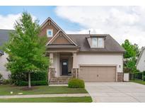 Charming home featuring stone accents, a covered entryway, and a two-car garage at 236 Lucky Ribbon Ln, Holly Springs, NC 27540