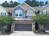 Charming townhouse with a two-car garage and a mix of stone and siding exterior at 238 Alamosa Pl, Cary, NC 27519
