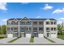 Charming townhome exteriors featuring varied siding colors, attached garages, and neatly manicured landscaping at 290 Grand Silo Rd, Raleigh, NC 27603