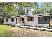 Beautifully renovated single-story home with painted white brick and professionally landscaped front yard at 3032 Dixon Rd, Durham, NC 27707