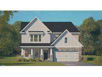 New two-story home featuring a two-car garage, covered porch, brick accents, and eye-catching vertical siding at 405 Falls Bluff Dr, Wake Forest, NC 27596