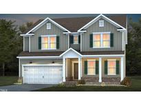 Charming two-story home featuring a two-car garage, green shutters, and inviting front porch at 465 Grange Farm Pl, Raleigh, NC 27603