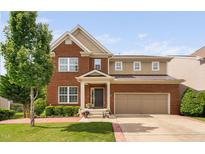 Beautiful two-story brick home featuring a two-car garage and manicured lawn at 5028 Blue Jack Oak Dr, Cary, NC 27519