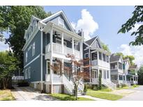 Charming two-story home with blue siding, inviting front porch, and landscaped front yard at 507 Rosengarten Aly, Raleigh, NC 27603