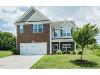 Charming two-story home featuring a brick and vinyl facade with a two car garage and well maintained lawn at 514 Alamanni Ct, Graham, NC 27253