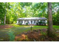 Charming single-story home with black shutters nestled in a wooded lot, offering privacy at 622 Enon Rd, Oxford, NC 27565
